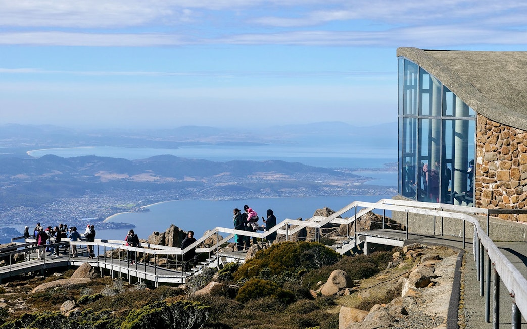 Visitors enjoying the view from kunanyi Mt Wellington lookout, Hobart, Tasmania.