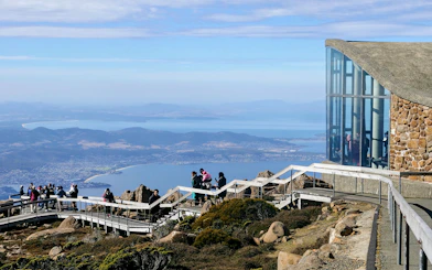 Visitors enjoying the view from kunanyi Mt Wellington lookout, Hobart, Tasmania.
