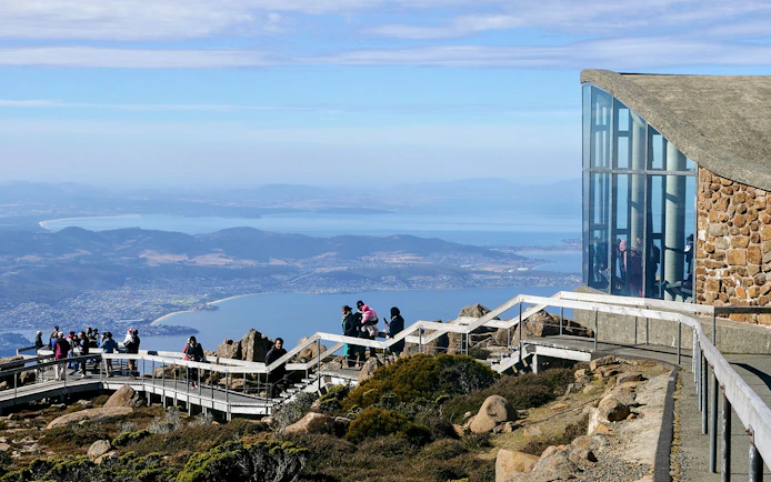 Visitors enjoying the view from kunanyi Mt Wellington lookout, Hobart, Tasmania.