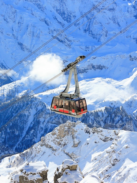Cable car ascending snowy mountains to Schilthorn - Piz Gloria from Stechelberg.