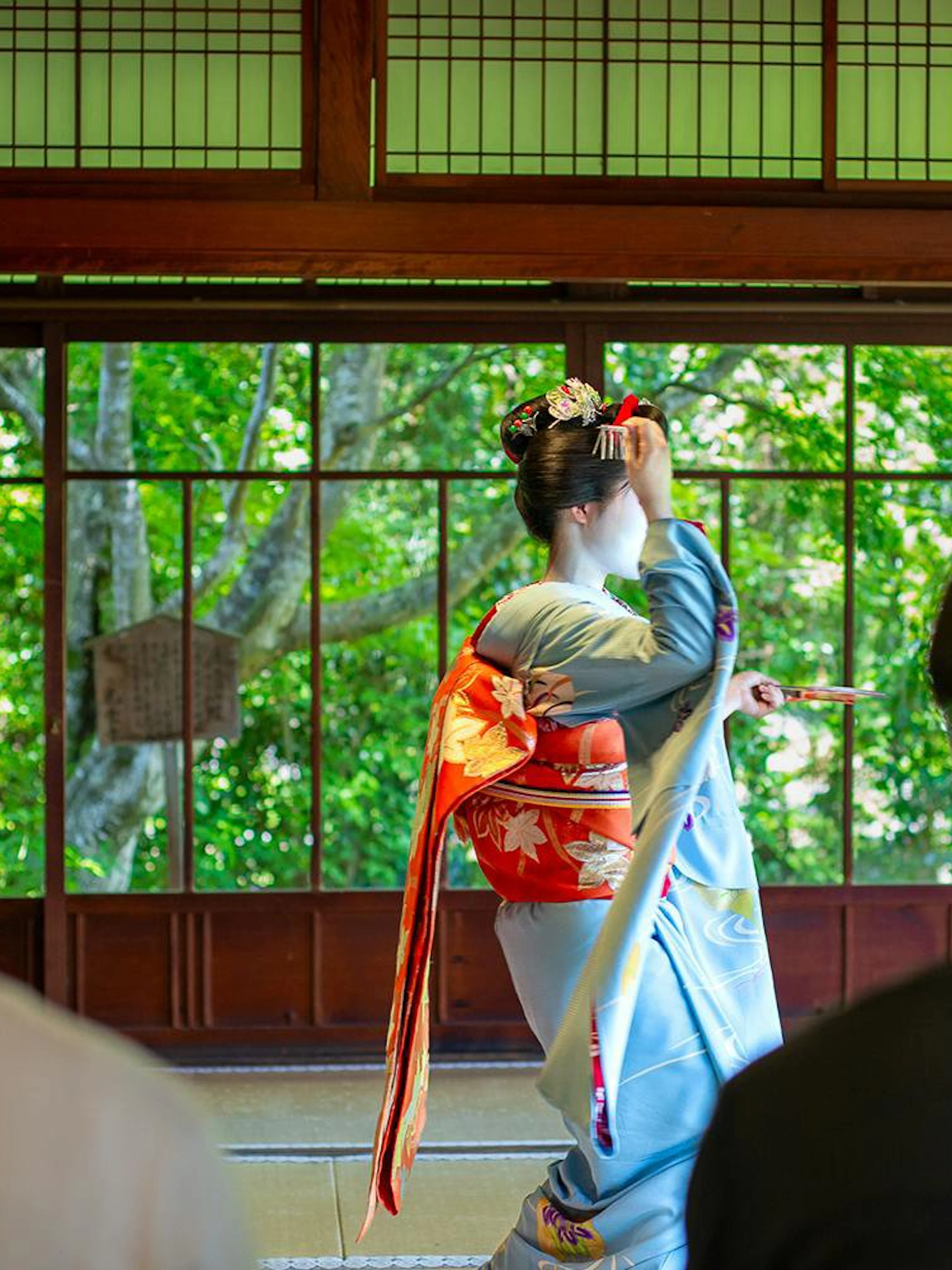 Tourists watching a Maiko perform in a Kyoto Zen temple.