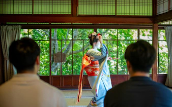 Tourists watching a Maiko perform in a Kyoto Zen temple.