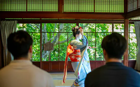 Tourists watching a Maiko perform in a Kyoto Zen temple.