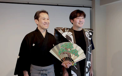 Kyoto Noh theater workshop with master performer holding a traditional fan.