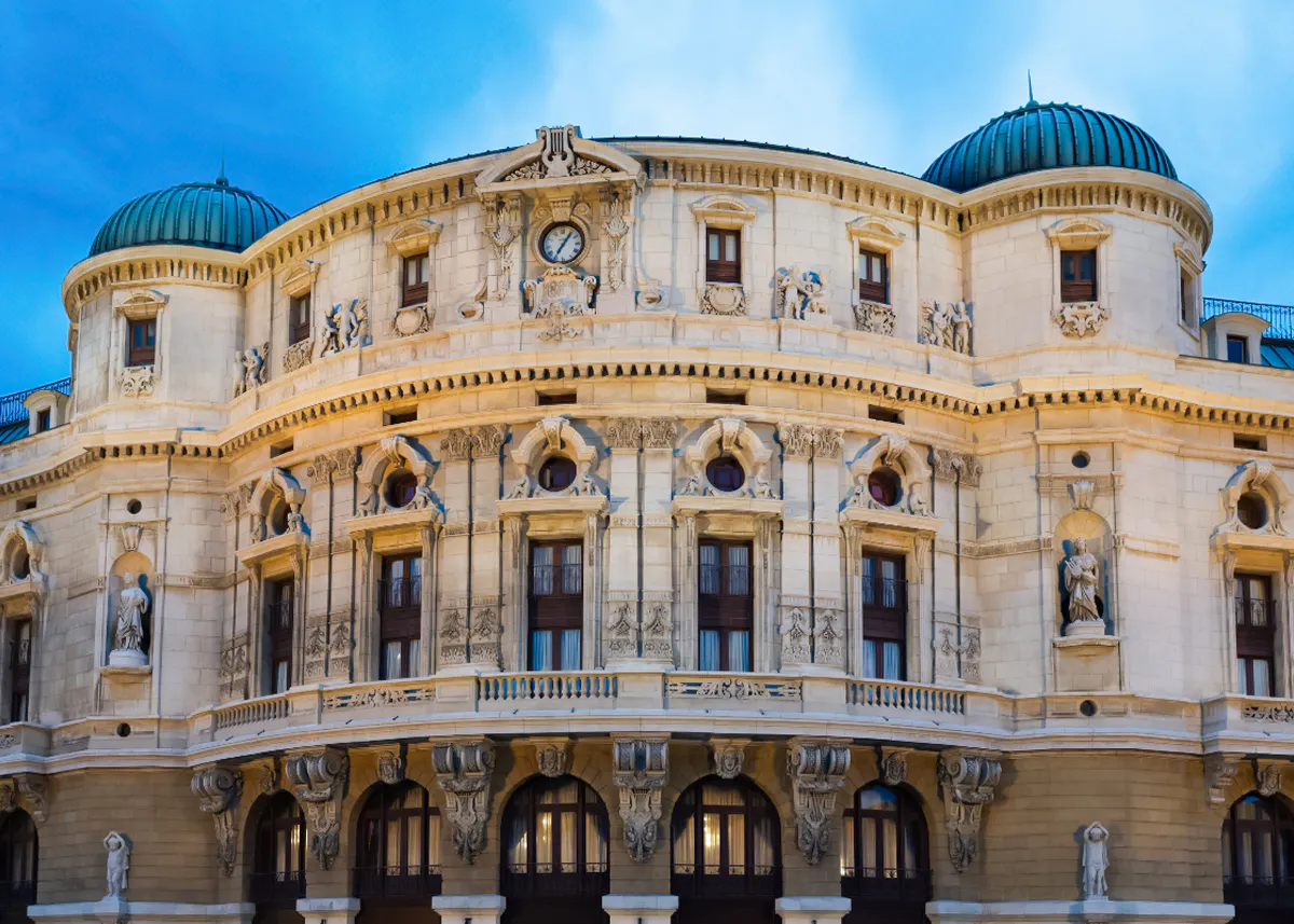 Ornate facade of a historic building in Bilbao, featuring sculptures and architectural details.