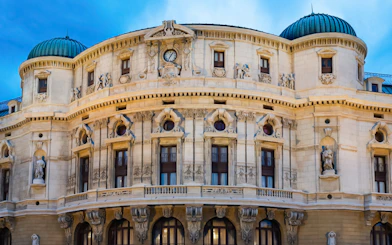 Ornate facade of a historic building in Bilbao, featuring sculptures and architectural details.