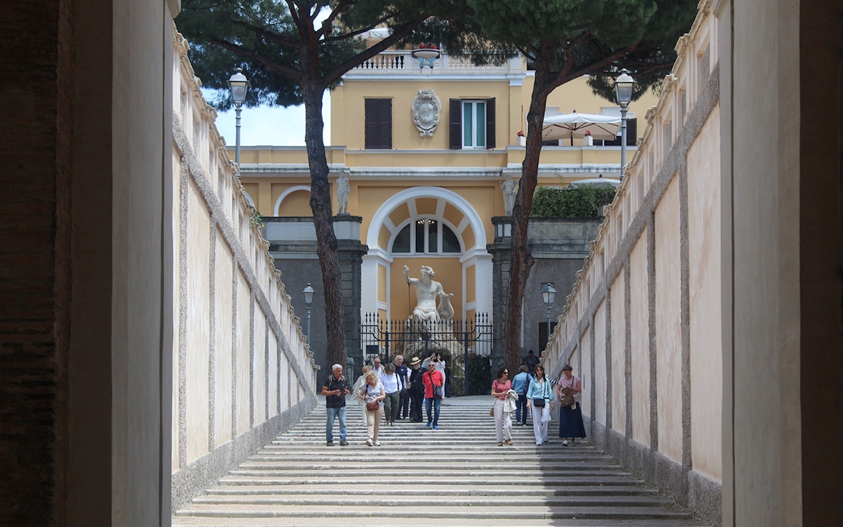 Visitors walking down steps at Palazzo Barberini entrance, Rome.