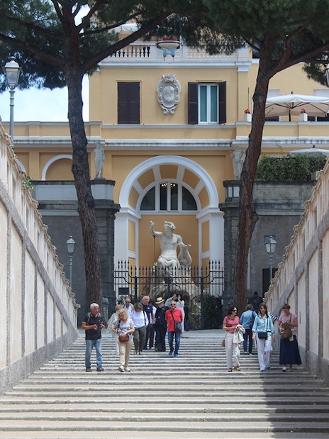 Visitors walking down steps at Palazzo Barberini entrance, Rome.