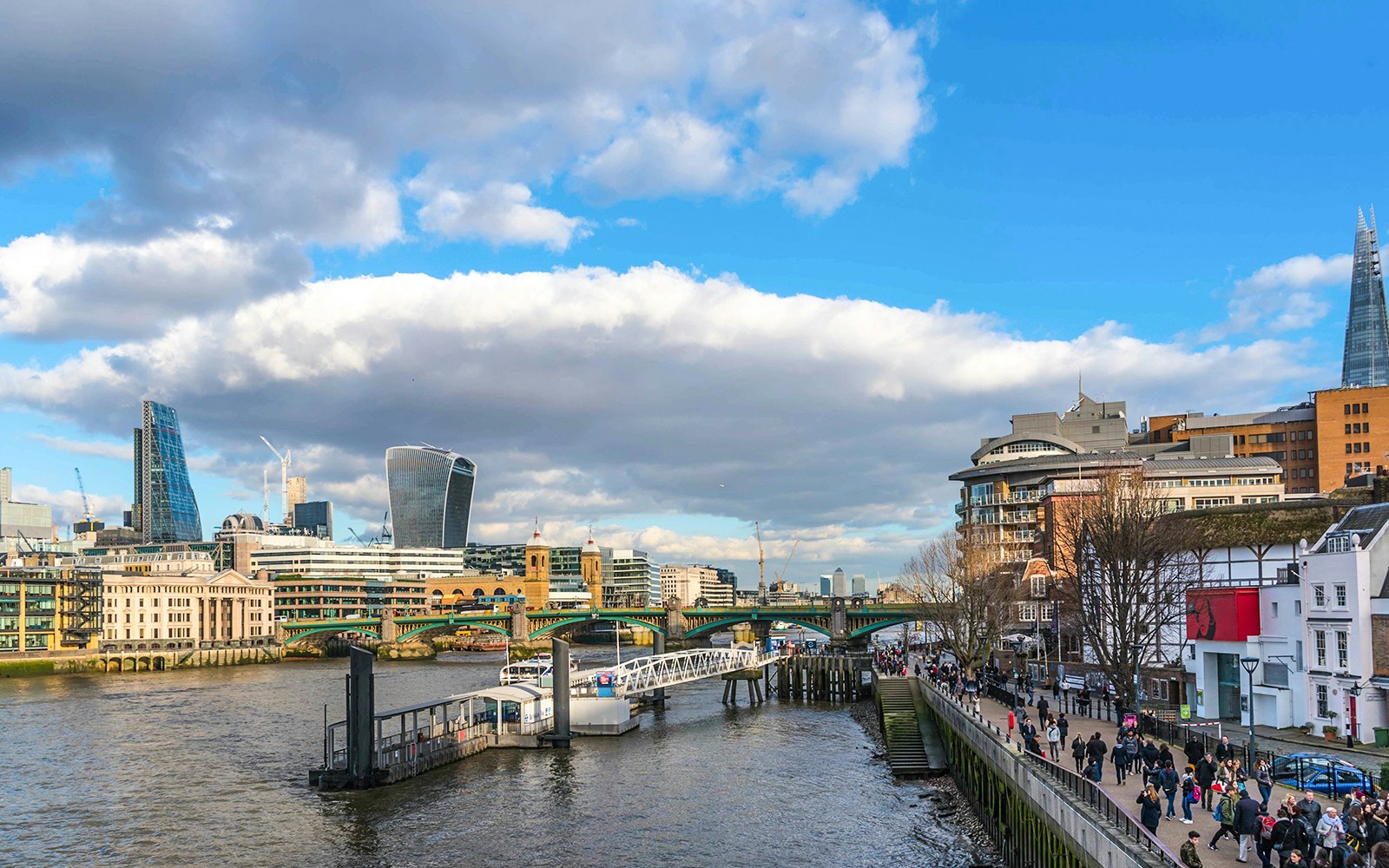 Bankside Pier with view of London skyline and River Thames.