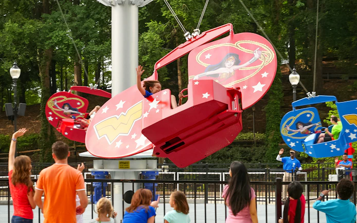 Children enjoying a Wonder Woman-themed ride at Six Flags Over Georgia.