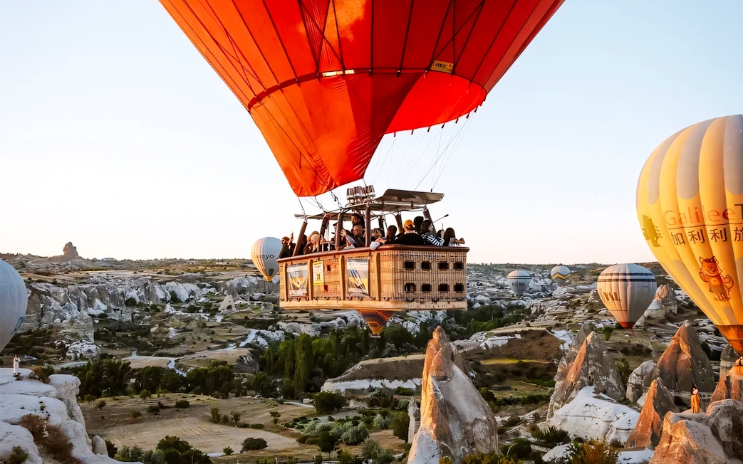 Hot air balloons over Cappadocia's unique rock formations.
