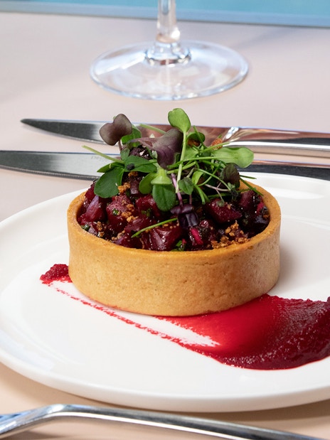 Three-course lunch tart with beet puree on Eiffel Tower day trip in Paris.