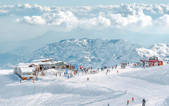 Farellones Park ski slopes with visitors, snowy Andes mountains in Santiago.