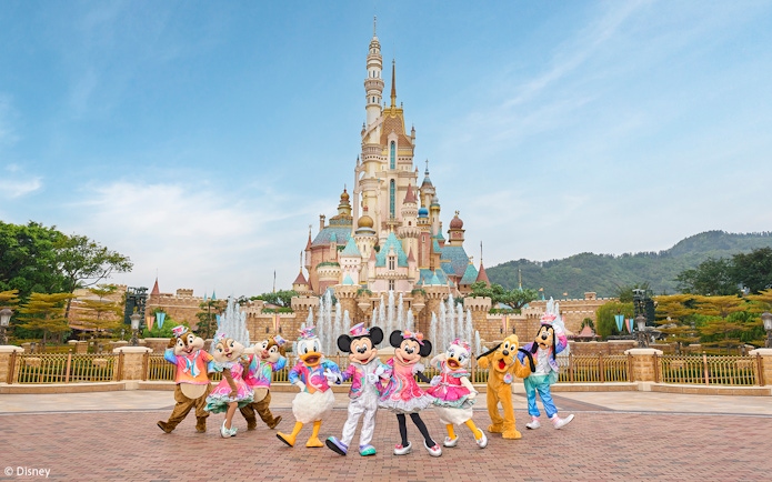 Disney characters celebrating 20th anniversary at Hong Kong Disneyland castle.
