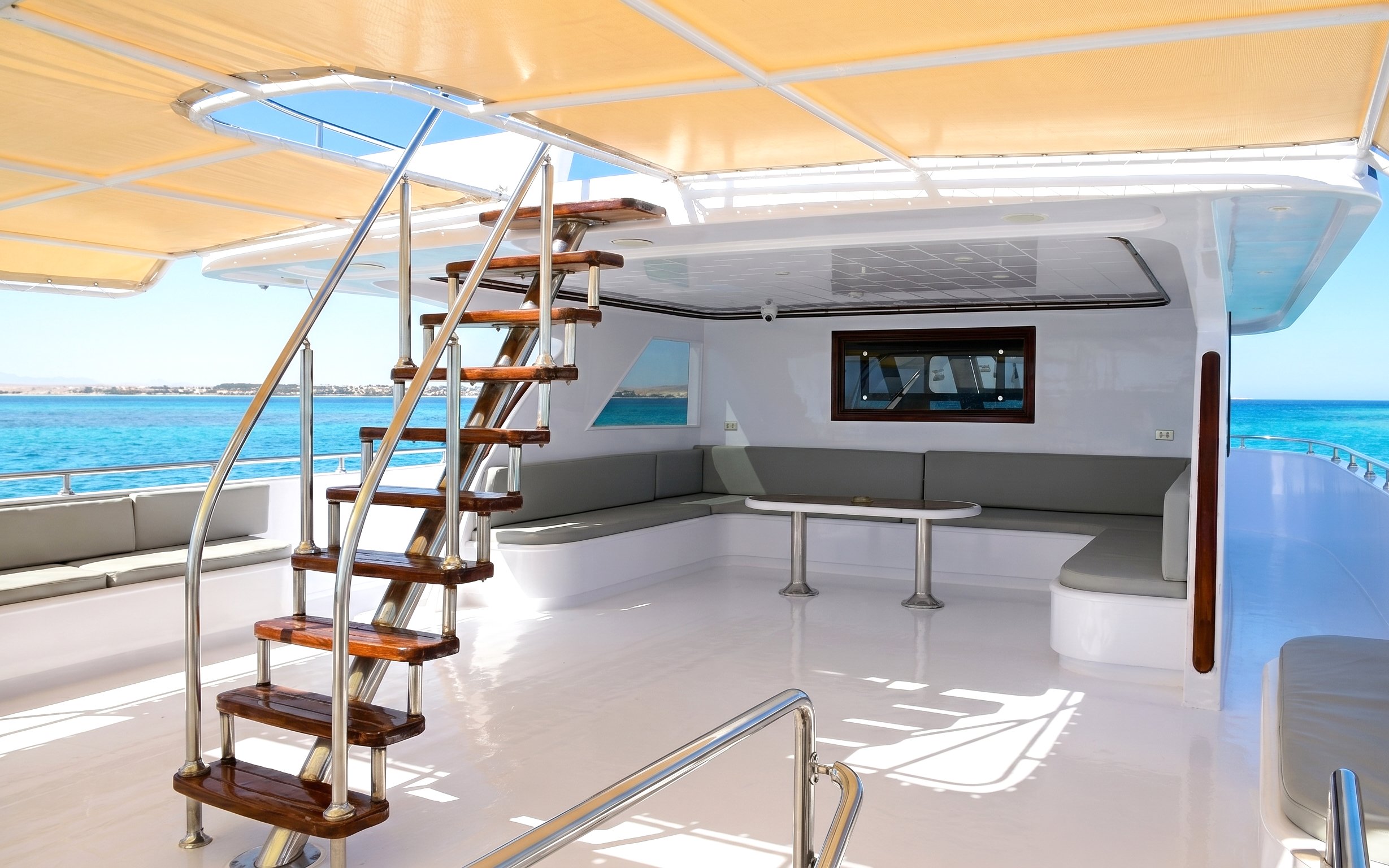 Boat deck with seating area and stairs, Orange Bay Island snorkelling trip, Hurghada.