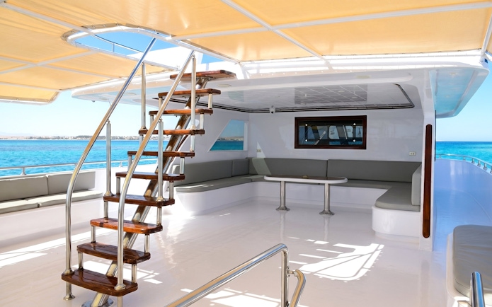 Boat deck with seating area and stairs, Orange Bay Island snorkelling trip, Hurghada.