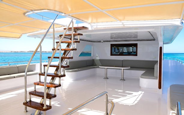 Boat deck with seating area and stairs, Orange Bay Island snorkelling trip, Hurghada.