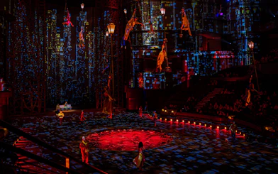 Acrobats performing at La Perle show in Dubai with vibrant cityscape backdrop.