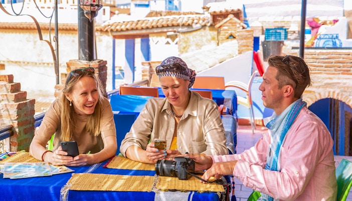 Tourists enjoying breakfast at a Moroccan cafe in Marrakech.