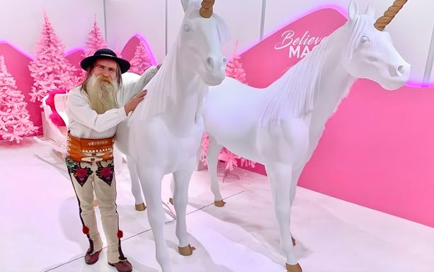Man with unicorn sculptures at Be Happy Museum, Zakopane.
