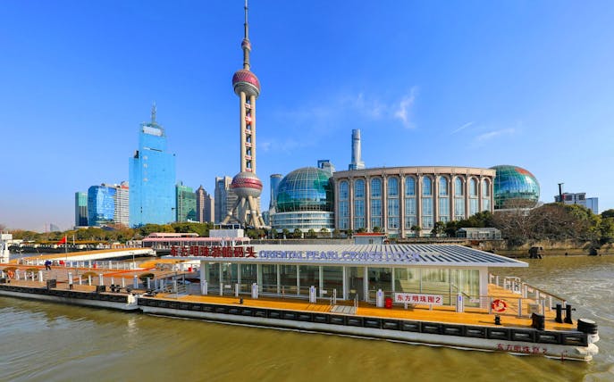 Oriental Pearl Cruise Terminal on Huangpu River with Shanghai skyline in background.