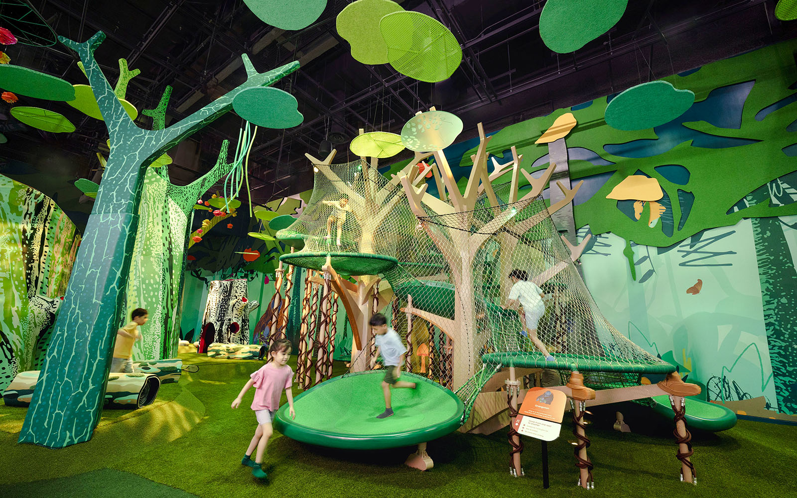 Children playing on a jungle-themed climbing structure at Forestland Orangutan Platform.