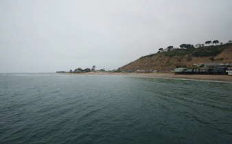 Santa Monica beach view with hills and ocean along Pacific Coast Highway.