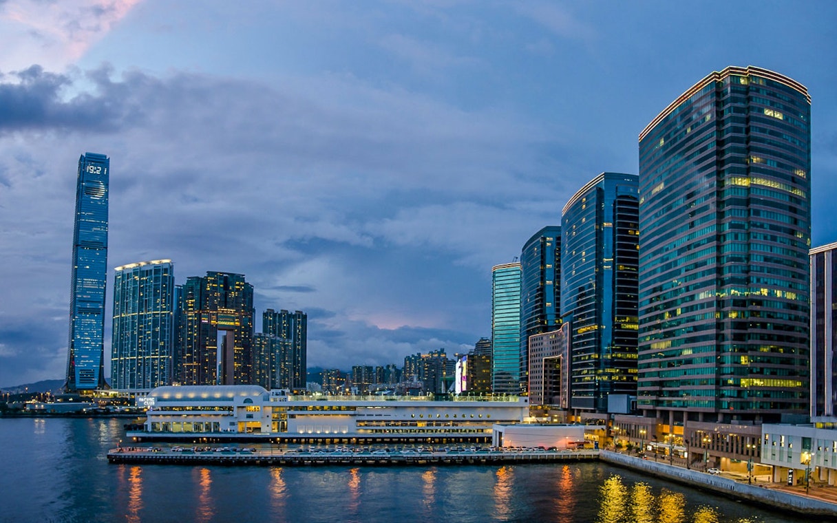 Hong Kong skyline at dusk during AquaLuna Harbor day tour.