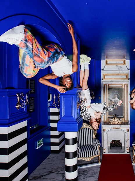 Visitors hanging upside down in the Royal Room at the Upside Down Amsterdam.