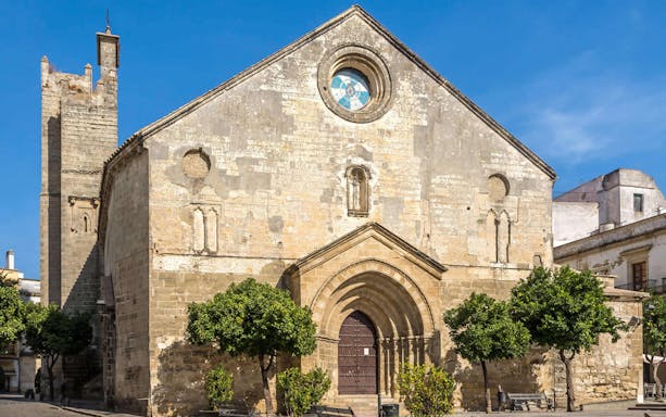 Church facade in Jerez, Spain, with arched entrance and tower, part of Seville day trip.