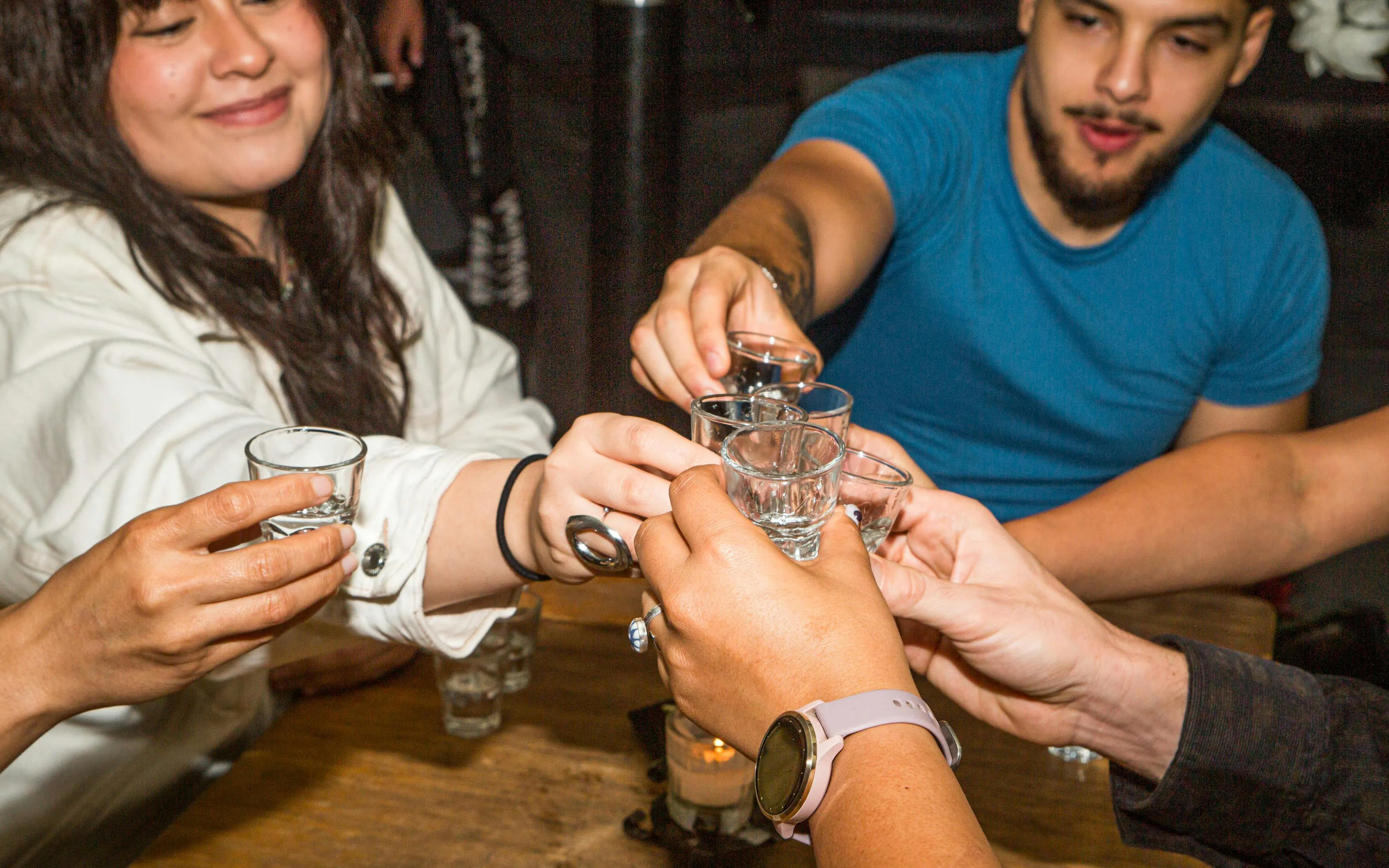Group toasting with mezcal shots in Mexico City.