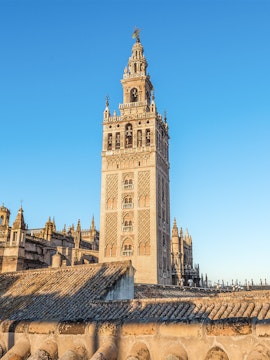 La Giralda tower in Seville, Spain, against a clear blue sky.