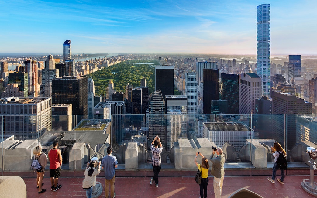 Visitors viewing Central Park and Manhattan skyline from Top of the Rock, New York City.