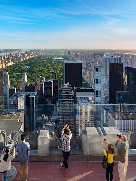 Visitors viewing Central Park and Manhattan skyline from Top of the Rock, New York City.