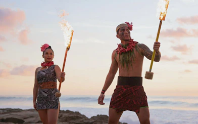 Performers with torches at sunset during Kaula-Luau in Hawaii.