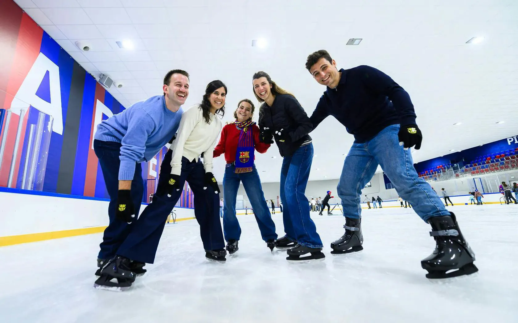 Group of people ice skating at FC Barcelona Ice Rink.