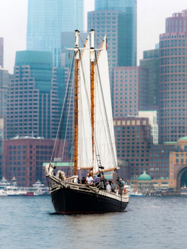 Liberty Star sailing in Boston Harbor with city skyline in background.
