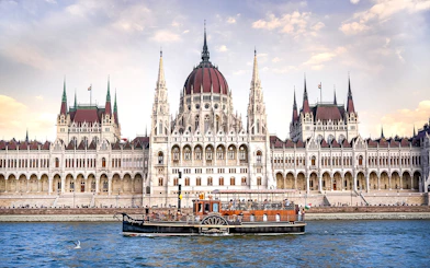 Cruise boat on the Danube River in front of the Hungarian Parliament Building, Budapest.
