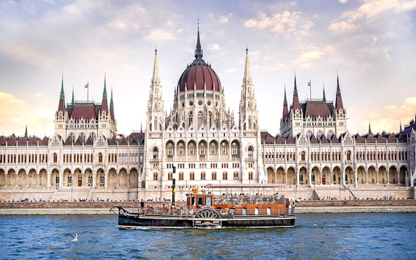 Cruise boat on the Danube River in front of the Hungarian Parliament Building, Budapest.
