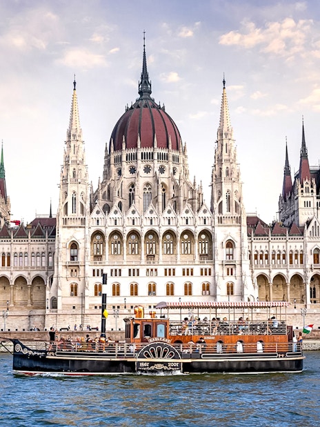 Cruise boat on the Danube River in front of the Hungarian Parliament Building, Budapest.