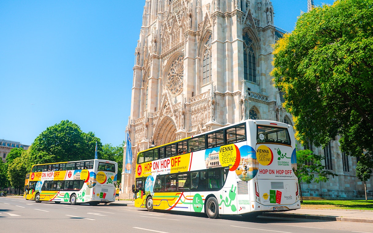 Vienna sightseeing hop-on hop-off buses near Votivkirche.