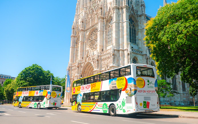 Vienna sightseeing hop-on hop-off buses near Votivkirche.