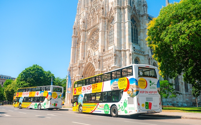 Vienna sightseeing hop-on hop-off buses near Votivkirche.