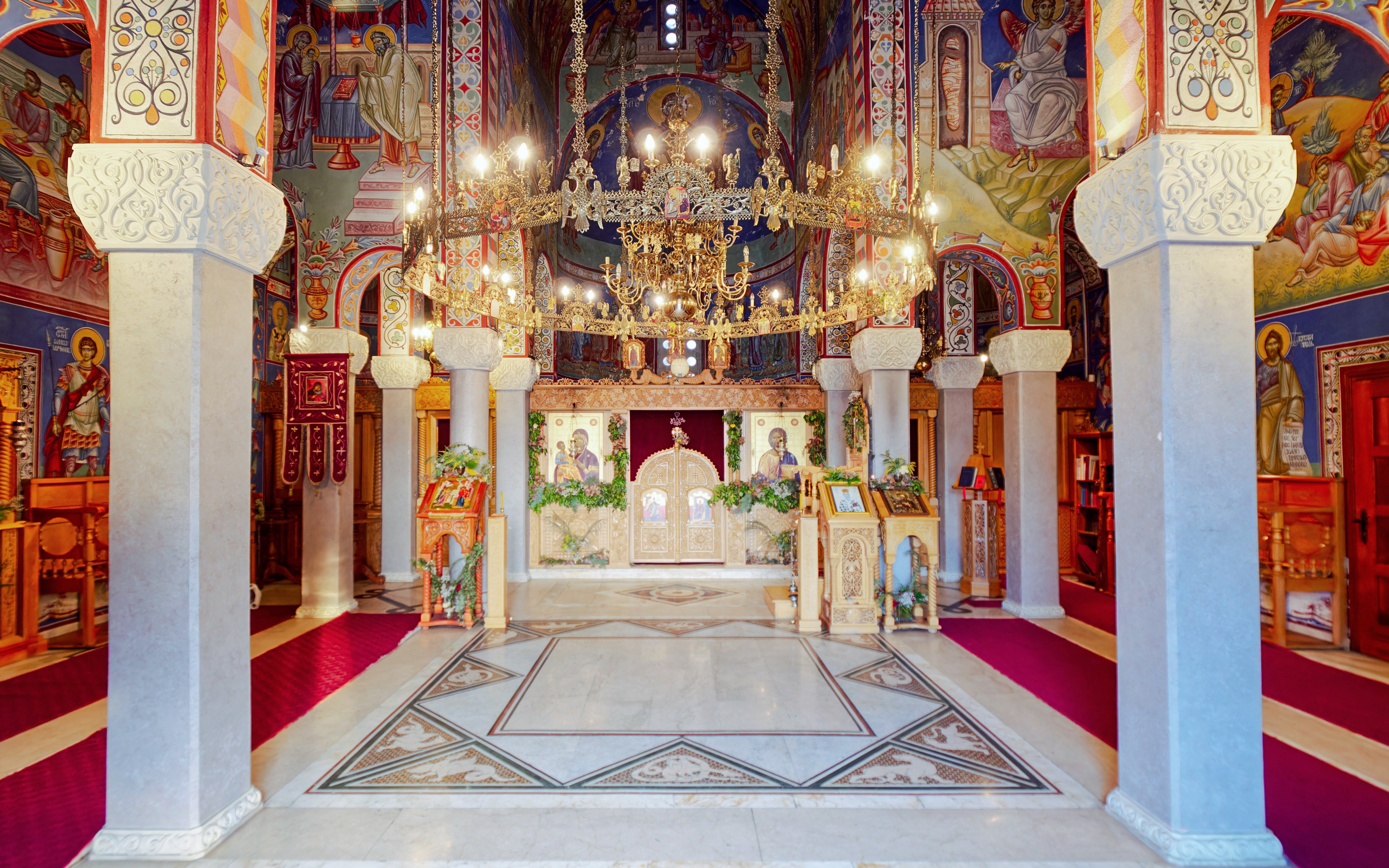 Interior of Hercegovačka Gračanica Monastery with ornate frescoes and chandeliers in Trebinje, Bosnia and Herzegovina.