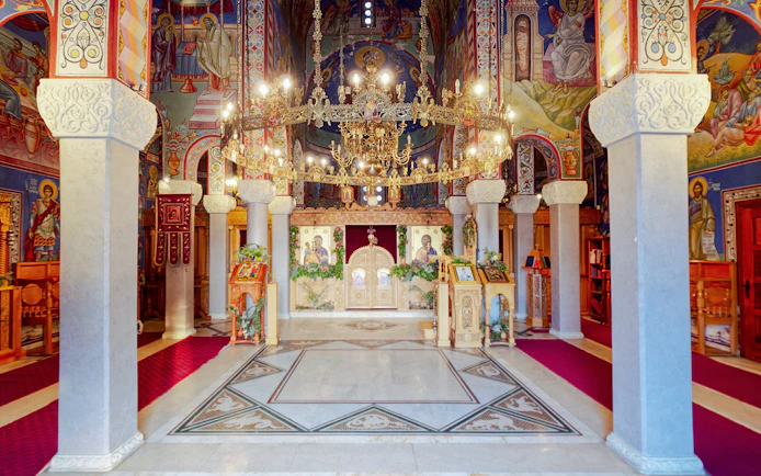 Interior of Hercegovačka Gračanica Monastery with ornate frescoes and chandeliers in Trebinje, Bosnia and Herzegovina.