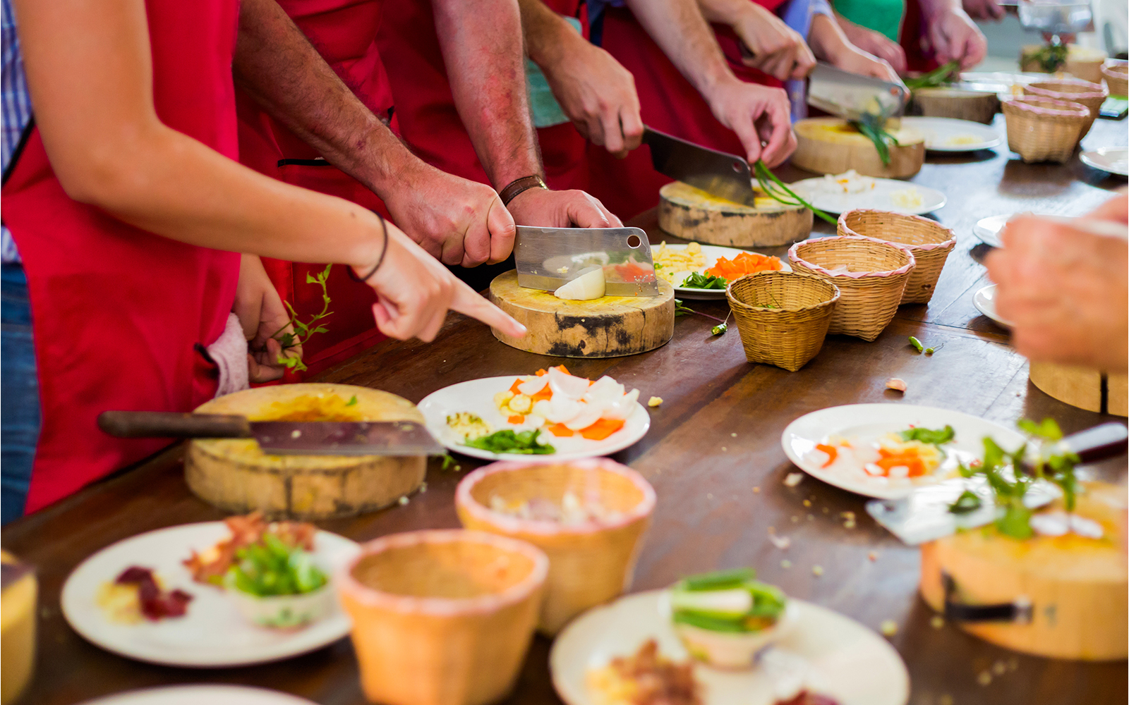 A group of people partaking in Thai cooking classes