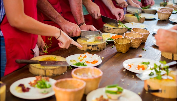 A group of people partaking in Thai cooking classes