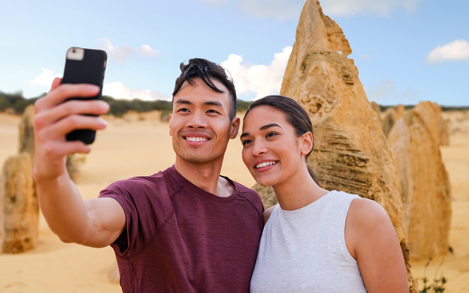 Couple taking a selfie at the Pinnacles Desert during a 1-day tour from Perth.