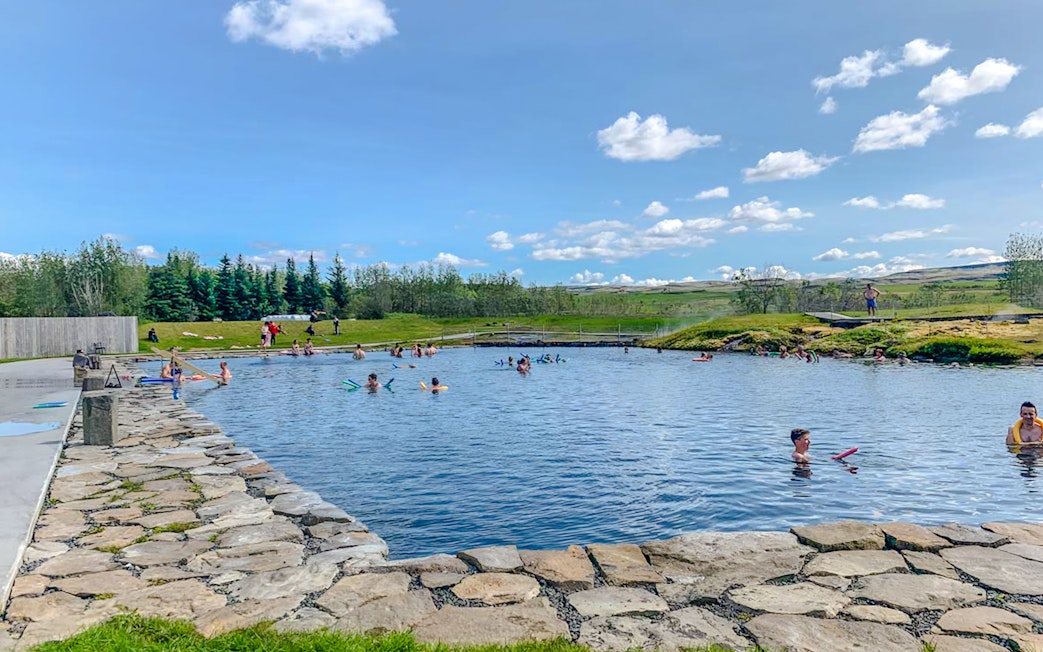 Visitors enjoying the Secret Lagoon's geothermal waters on the Golden Circle near Reykjavik.