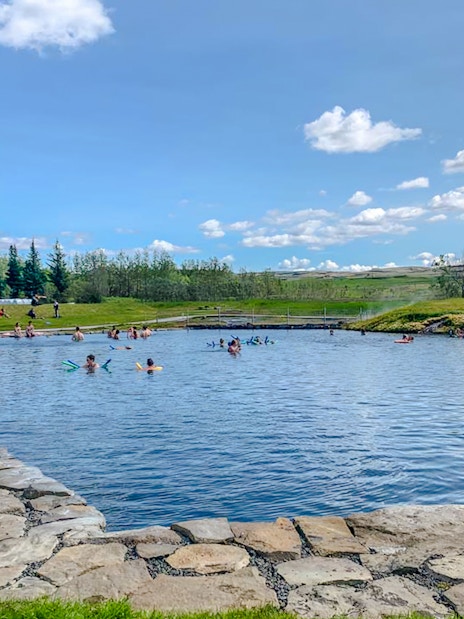 Visitors enjoying the Secret Lagoon's geothermal waters on the Golden Circle near Reykjavik.